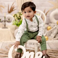 This little gentleman is one year old! We styled this classic first birthday portrait with a clean, rustic backdrop and simple props to let his adorable personality and smart outfit take center stage.