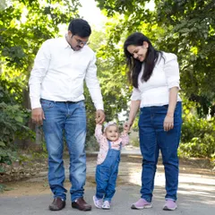 Taking her first steps with mom and dad. Outdoor lifestyle sessions are perfect for capturing natural family moments and milestones in a beautiful setting.