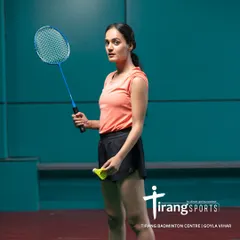 A player ready to serve, showcasing the focus and determination we see on our courts every day. Our facilities cater to both competitive players and those just starting their badminton journey.