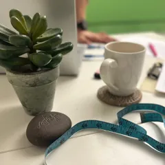 The tools of the trade. A measuring tape, a coffee cup, and a plan. This is where the behind the scenes work happens for our transformation programs, ensuring every detail is covered.