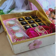 A look at one of our popular Diwali hampers, perfect for corporate or personal gifting. This elegant basket contains a box of our artisan chocolates, decorative diyas, and a traditional coin pouch.