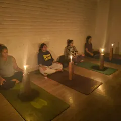 Expecting mothers practicing Tratak meditation. By focusing on the steady flame, they learn to quiet the mind and listen to their inner selves, creating a peaceful environment for the life growing within.