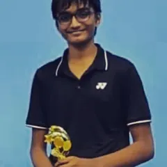 A proud winner holding his trophy. Each victory, big or small, is a milestone that we celebrate as a team at the academy.
