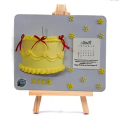 Another version of the popular floating frame cake. The yellow cake with red ribbons creates a bright and cheerful piece of edible art for a birthday celebration.