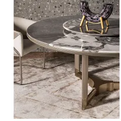 A piece of advice for dining tables: always opt for a marble top for durability and timeless elegance. This custom table features a dual-toned marble top and a sculptural metal base, showcasing our expertise in bespoke furniture.