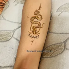 A close-up of the dragon tattoo, showing the fine lines and details.