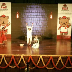 A dramatic scene from the Maple Bear annual day, where I incorporated simple but effective props and stage lighting to enhance the storytelling. The stage is decorated with traditional marigold garlands for a festive touch.
