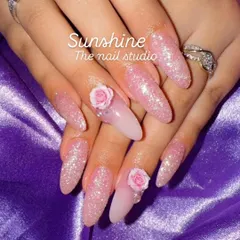 A dreamy pink set featuring full glitter nails and accent nails with 3D roses. This is a perfect example of a glamorous, feminine design that's popular for special occasions.