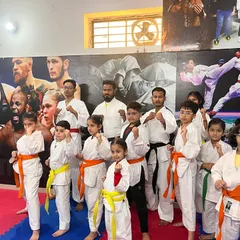 A group of my young students, from white belts to black belts, ready for their karate class. Discipline and respect are the first lessons they learn.