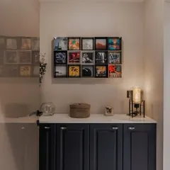 We elevated this entryway with a stunning indigo blue foyer unit. The piece features elegantly routed shutters, a crisp white European membrane top, and sleek black knobs, all crowned by captivating wall art.