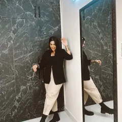A playful pose in my Pinterest-recreated outfit. The combination of a tailored blazer with casual trousers and boots is a perfect example of smart-casual style.