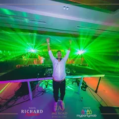 In my element, hands up with the crowd, surrounded by a sea of green lasers. This shot from a New Year's Eve party captures that perfect moment of connection when the music and the lights all hit at once.