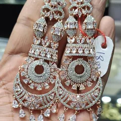 A pair of stunning American Diamond chandbalis in a rose-gold finish. The intricate design is fully studded with sparkling stones, giving it a very rich and luxurious look for any special event.