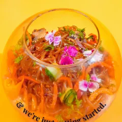 This is my Shirataki Noodle Bowl, a light and flavourful Korean inspired dish. The glass noodles are tossed with fresh vegetables and a zesty dressing, then garnished with edible flowers.