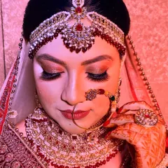 This is another example of my bridal makeup artistry. The focus is on creating a look that is both glamorous for photos and long-lasting for the entire event, featuring shimmering eyeshadow and perfectly sculpted features.