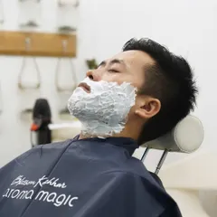 A rich, warm lather is applied to soften the beard and protect the skin. This step is crucial for achieving a close yet comfortable shave, allowing the razor to glide effortlessly.