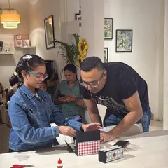 A father and daughter working together on a paper craft project. It's wonderful to see families collaborating and sharing a creative moment in the studio.
