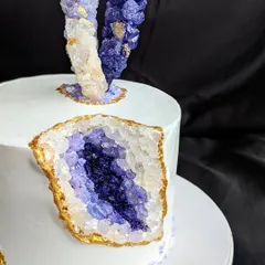 This is my signature geode cake, featuring a dramatic crystal cavity made from homemade rock candies and highlighted with edible gold. It's a modern, trendy design that brings a touch of geological wonder to your celebration.