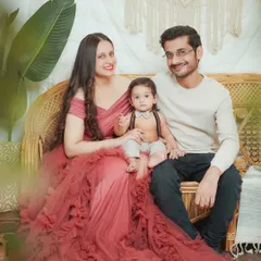 A beautiful family portrait in our boho-themed studio. The mother wears one of our client gowns, perfectly complementing the relaxed and warm setting.