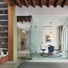 Transparent glass walls and a large arched window allow our conference room to be visually connected to the rest of the office, while a warm timber ceiling adds a welcoming touch.