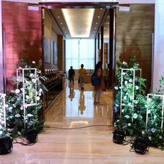 The entrance to the Fairfield by Marriott ballroom, framed with our custom floral stands and uplighting. This setup creates an elegant transition for guests as they enter the main event space for an evening gala.