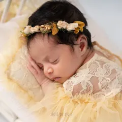 A close-up of a sleeping baby, showcasing the delicate features and peaceful expression. I use soft lighting to enhance the natural beauty of your newborn.