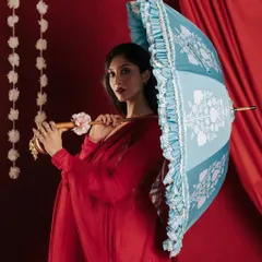 By introducing a contrasting color with this light blue umbrella, I created a visually striking image that stands out within the series. The pose highlights the product's structure and ruffled edges, providing a clear view for potential customers.