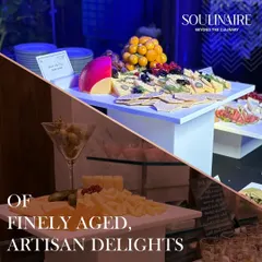 Indulge in our selection of finely aged, artisan delights. This display showcases a variety of textures and tastes, artfully presented with crackers and fruit, ideal for any connoisseur.