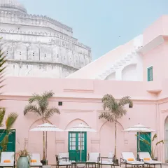 The stunning pink architecture and tranquil pool of Ranbaas The Palace in Patiala, a perfect example of a heritage venue that blends history with modern luxury.