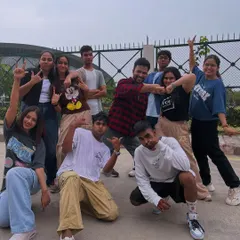 The whole crew looking cute during a video shoot. This candid shot captures the fun and relaxed atmosphere of our dance projects.