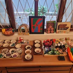 A beautifully arranged tray of sewing and embroidery materials. We believe that presenting materials with care and beauty inspires children to treat them with respect and engage with the work more deeply.