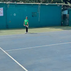 A young competitor stands ready on the court during the Inter School Tennis Tournament, showcasing the focus we instill in our players.