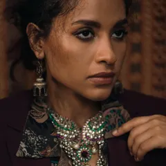 For this regal-themed shoot, I used warm, directional lighting to mimic the feel of an old painting. The focus is on the intricate details of the layered jewelry and the rich textures of the clothing, creating a sense of timeless opulence.