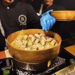 Our live dim sum station is a guaranteed crowd-pleaser. Here, our chef carefully arranges freshly steamed dumplings in a traditional bamboo basket, ready to be served hot to your guests.