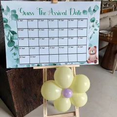 Interactive fun for a baby shower. We designed this 'Guess The Arrival Date' game board on an easel, decorated with a small balloon flower, to get guests involved in the celebration.