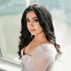 A modern Catholic bride. For this look, I created a dramatic brown smudged kohl eye, balanced with a glossy nude lip and soft, romantic curls to go with her beautiful white gown.