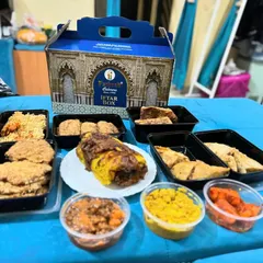 Here is a full spread from one of our popular Iftar boxes. You can see the generous portions of snacks like Russian cutlets and samosas, our special Baida Roti, and sides like chana and aloo, making it a complete and satisfying meal.