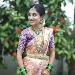 This bride looks absolutely regal in a Victorian-style antique jewellery set with green stone accents. The layered necklaces and matching waist belt create a cohesive and grand look for her wedding day.