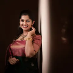 A professionally shot portrait of a party guest. The lighting highlights the flawless makeup application and her radiant smile.