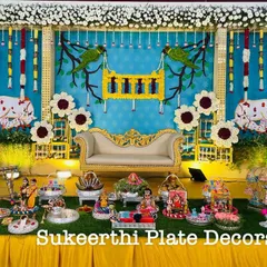 This baby shower setup features a lovely traditional backdrop with parrots and a cradle theme. I used German silver plates and stands to display the seer items, creating a classic and auspicious look.