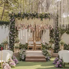 A mandap should feel like a sanctuary. For this outdoor wedding, we designed a breathtaking floral mandap with cascading white and lilac flowers, creating a serene and romantic atmosphere for the couple to exchange their vows.