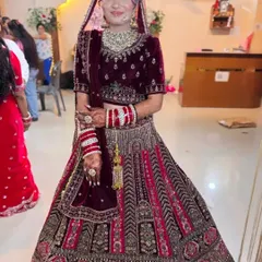 A stunning bride in her full wedding attire. Her intricate mehndi is a beautiful accessory that completes her regal look.