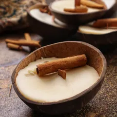 My Cinnamon Coconut Soy Candle, poured in a natural coconut shell with a real cinnamon stick. The scent was inspired by the warm, comforting smell of mom's chai.