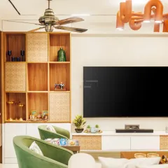 This detailed shot focuses on the craftsmanship of the wooden cabinetry and the interplay of textures. The combination of smooth white surfaces, natural wood, and woven rattan adds depth and tactile appeal to the living space.