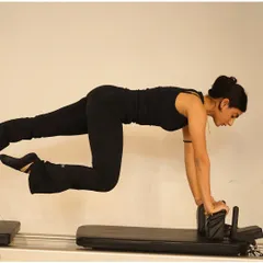 This challenging plank variation on the reformer requires immense core control and strength. It's a perfect example of how we work to build a strong, stable center.