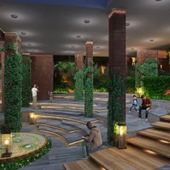 The stepped seating of the open-air amphitheater at Atmanya is integrated into the landscape. This space, featuring brick pillars with climbing vines, is designed for relaxation and communal gatherings.
