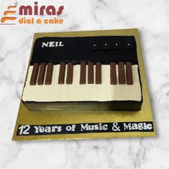 Celebrating 12 years of music, this piano keyboard cake was made entirely without fondant. The keys and details are crafted from rich chocolate and buttercream for a sleek, delicious finish.