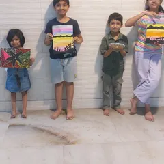 A group of proud young artists showing off their finished paintings. My art classes are for all age groups, and it's wonderful to see them create together.