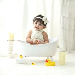 Our signature bathtub photoshoots are a favorite among parents and toddlers. This clean, all white setup with classic rubber ducks creates a simple yet adorable portrait that is timeless and full of fun.