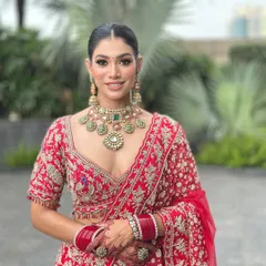 A full portrait of my beautiful bride in a classic red lehenga. I focused on creating a luminous skin finish and defined eyes to complement her traditional wedding attire and heavy jewellery, ensuring she looked absolutely regal.